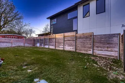 Spacious backyard with a lush lawn, perfect for outdoor games, relaxation, and barbecues.