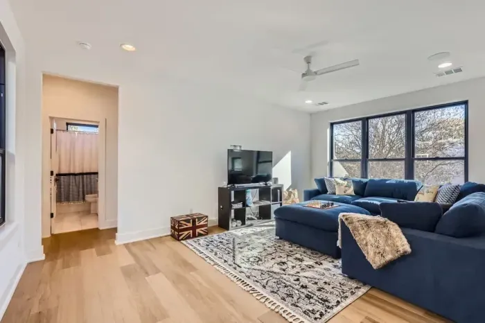 Comfortable second living area with a large flat-screen TV, ideal for watching sports or streaming movies.