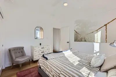 Romantic bedroom with elegant lighting and soft, neutral tones.