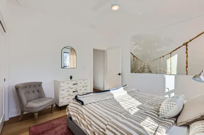 Romantic bedroom with elegant lighting and soft, neutral tones.