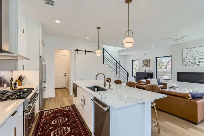 Bright and modern kitchen with stainless steel appliances, perfect for preparing a gourmet meal or quick snacks.