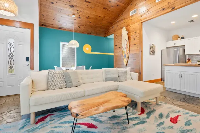 Elegant living space with vibrant coastal décor and airy open-plan design.