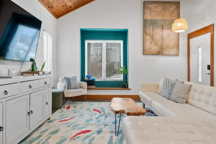 Inviting lounge space with coastal artwork and comfortable seating.
