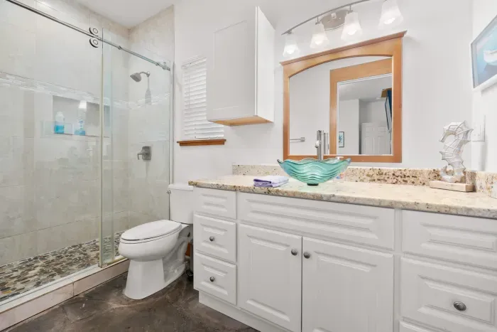 Elegant bathroom with a large walk-in shower and bright vanity space.