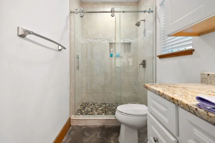 Spa-inspired primary bathroom with a spacious walk-in shower and coastal finishes.