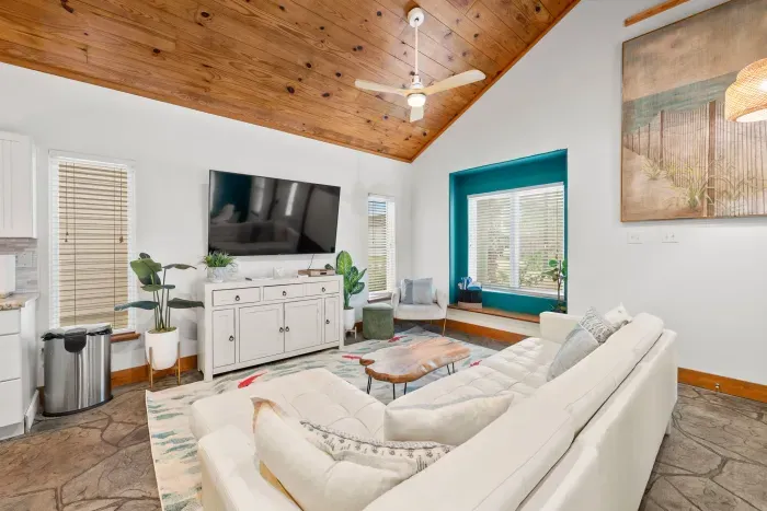Bright coastal living room with vaulted ceilings and chic beach décor.