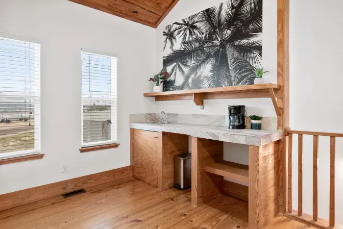 Private loft-style bedroom with relaxing tones and warm wood accents.
