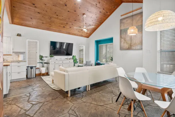 Open-concept living area with vaulted ceilings and elegant beach-house charm.