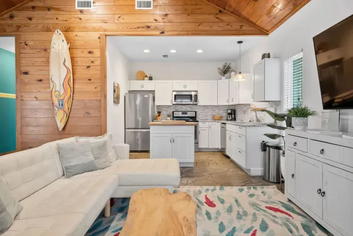 A bright and inviting living room with coastal textures and warm wood accents creating a luxurious beach-house atmosphere.