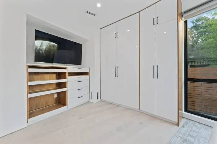 Modern bedroom with minimalist design and high-quality bedding.