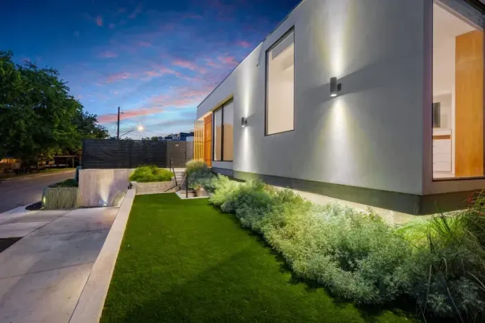 Spacious front yard with beautiful greenery and inviting entry.