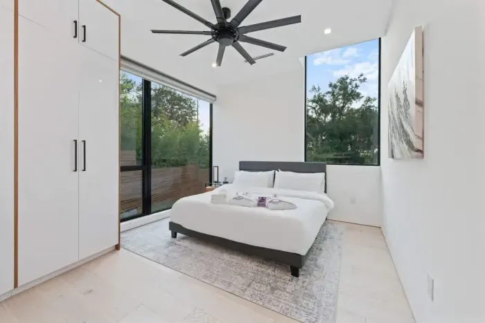 A contemporary queen-size bed and minimalist design create a peaceful, stylish atmosphere to rest in.