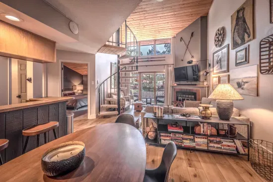 Inviting open living area with high ceilings and warm wood tones.