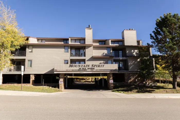 Front building view showcasing the peaceful mountain setting.
