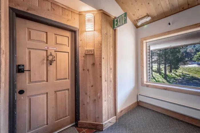 Bright entry hallway with natural light and wood accents.