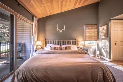Spacious bedroom with a plush bed and private balcony access.