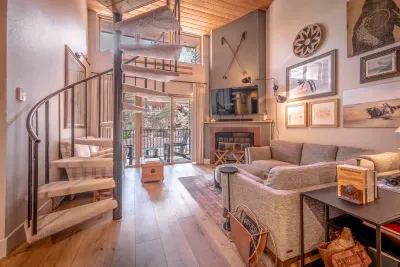Warm sunlit living room with cozy seating and mountain cabin charm.