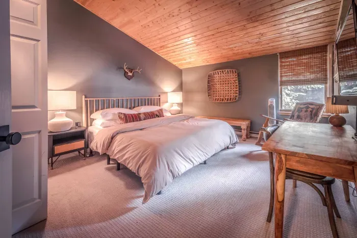 Cozy bedroom with warm lighting and mountain cabin charm.