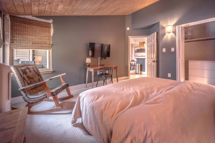 Spacious bedroom with soft bedding and relaxing decor.