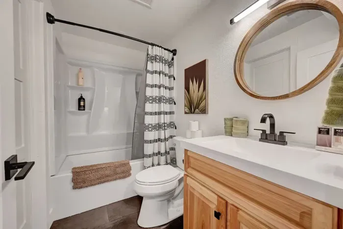 Modern full bathroom with wood vanity.