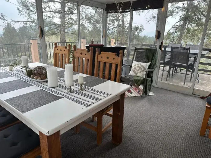 Enclosed patio with large dining table.