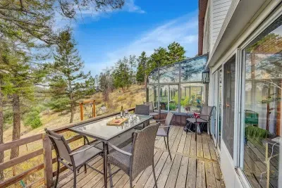 Scenic patio with forest and mountain views.