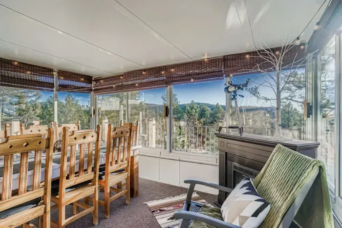 Inviting sunroom perfect for dining or relaxing with a view.