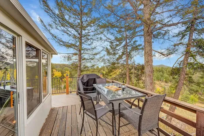 Patio dining with peaceful forest views.