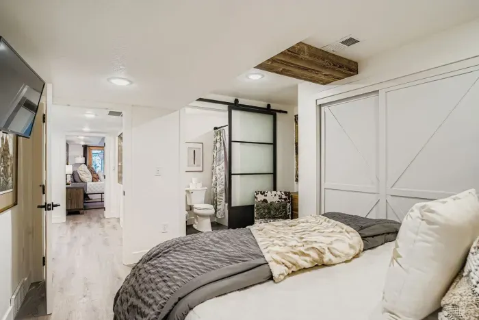Elegant bedroom suite with barn doors and cozy retreat feel.