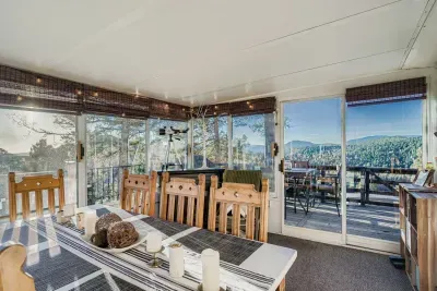 Dining area in the sunroom with mountain views all around.