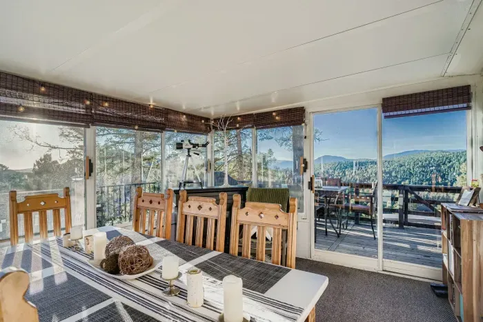 Dining area in the sunroom with mountain views all around.
