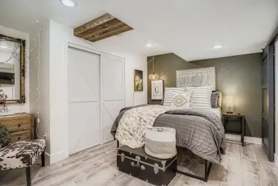 Primary suite with king bed and modern rustic finishes.