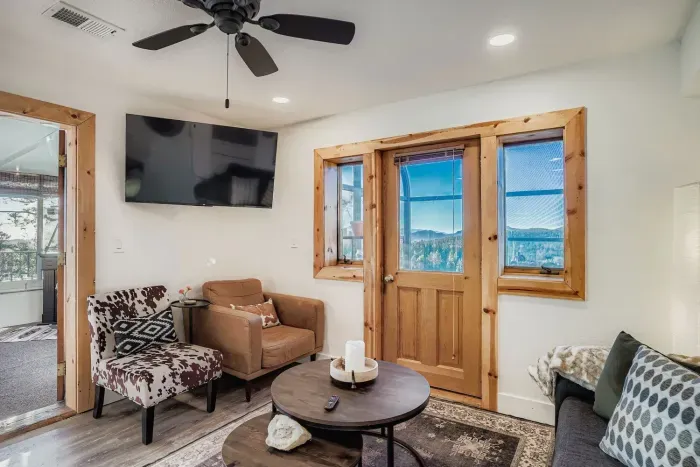 Spacious living area with smart TV and comfortable seating.