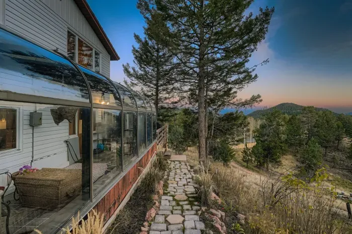 Cozy mountain retreat exterior with stunning sunset skies.