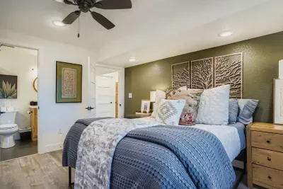 Cozy second bedroom with plush bedding and warm lighting.