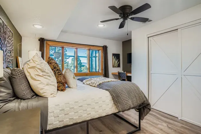 Primary bedroom featuring a luxurious king bed and mountain views.