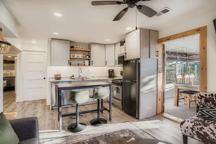 Modern kitchen with stainless steel appliances and rustic wood accents.