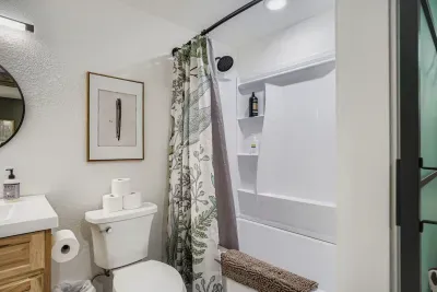 Modern bathroom with double vanity and spa-style shower.