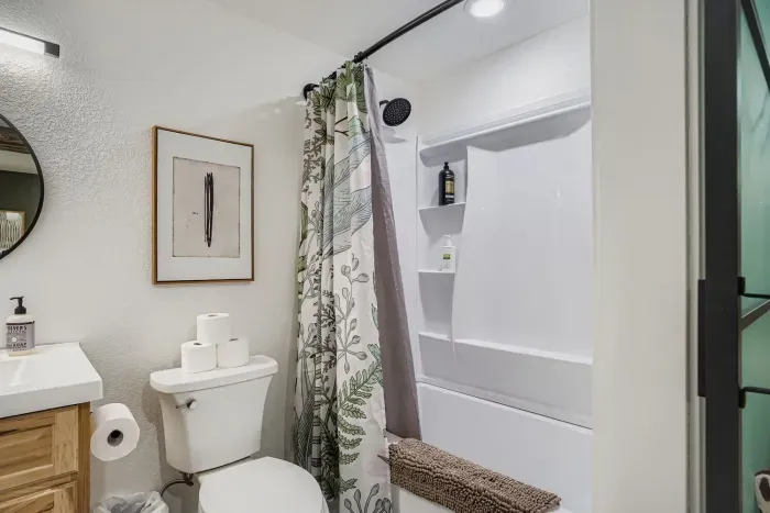 Modern bathroom with double vanity and spa-style shower.