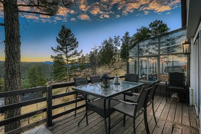 Expansive balcony with outdoor seating and breathtaking mountain views.