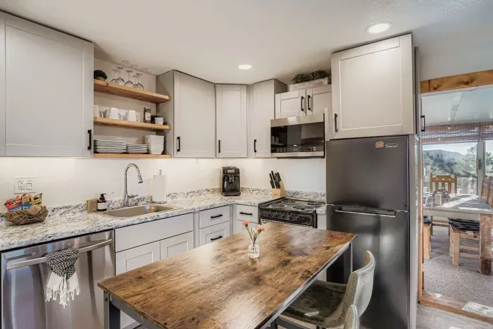 Fully equipped kitchen with open shelving and farmhouse charm.