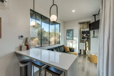 Stocked kitchen with microwave and cooktop with waterfall kitchen peninsula doubling as a workspace and cooking area