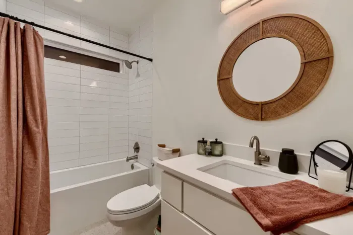 A refreshing, clean bathroom with charming decor and all the essentials.
