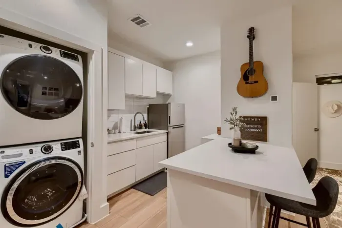 Well equipped kitchen with modern appliances and a convenient laundry area for everyday use.