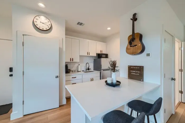 Kitchen with full size washer and dryer, microwave, hot plate, coffee maker, and refrigerator