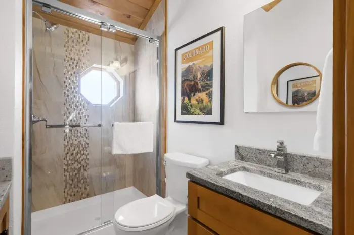 Elegant bathroom featuring a luxurious marble countertop. The sleek design combines style and functionality, creating a sophisticated space for relaxation. With its timeless appeal, the marble top adds a touch of luxury, making this bathroom both bea