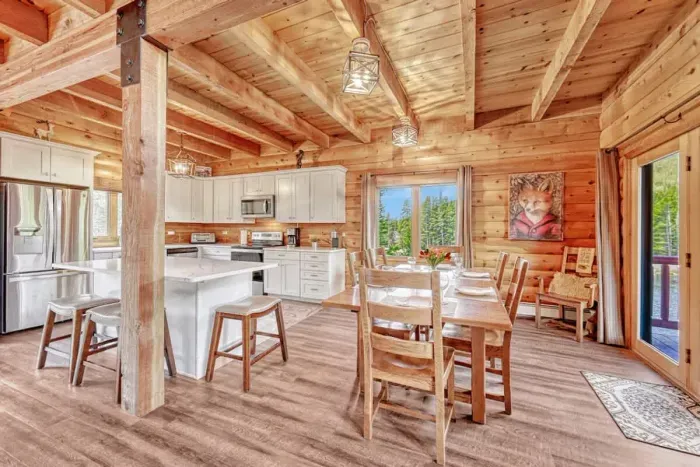 Charming kitchen and dining featuring elegant wood cabinetry and accents, creating a warm and inviting atmosphere. This space combines functionality with natural beauty, providing an ideal setting for cooking and gathering.