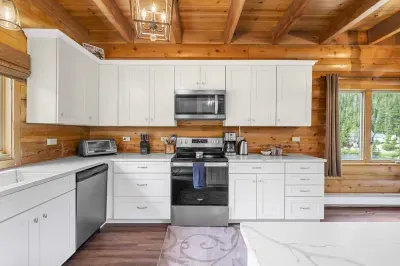 Spacious kitchen with a large island and seating, ideal for enjoying morning coffee or group meal prep.