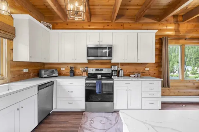 Spacious kitchen with a large island and seating, ideal for enjoying morning coffee or group meal prep.