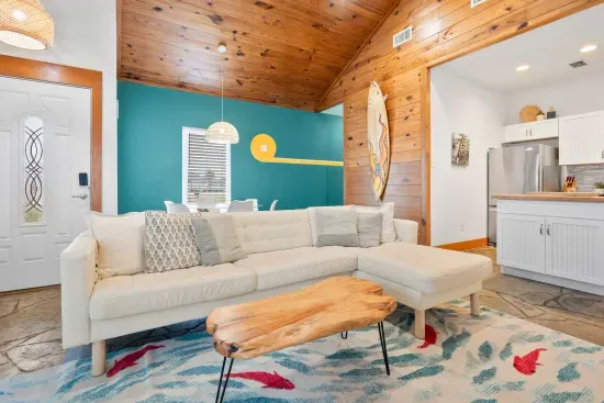 Elegant living space with vibrant coastal décor and airy open-plan design.